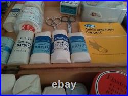 Vintage medical equipment with bandages supplies and tins, collectors boots