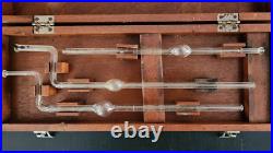 Vintage old medical science glass tubes beakers lab equipment in wooden box