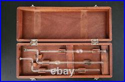 Vintage old medical science glass tubes beakers lab equipment in wooden box